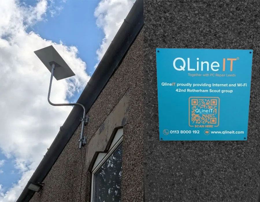 Printed banner at the scout site reading QLine IT proudly providing internet and Wi-Fi for the 42nd Rotherham Scout group